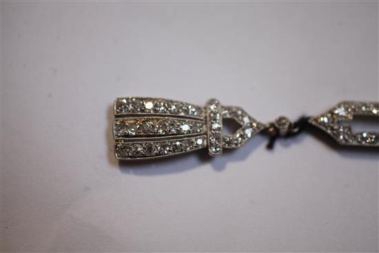 A 19201930s Art Deco 18ct gold, platinum and platinum set open work drop pendant, pendant 55mm.